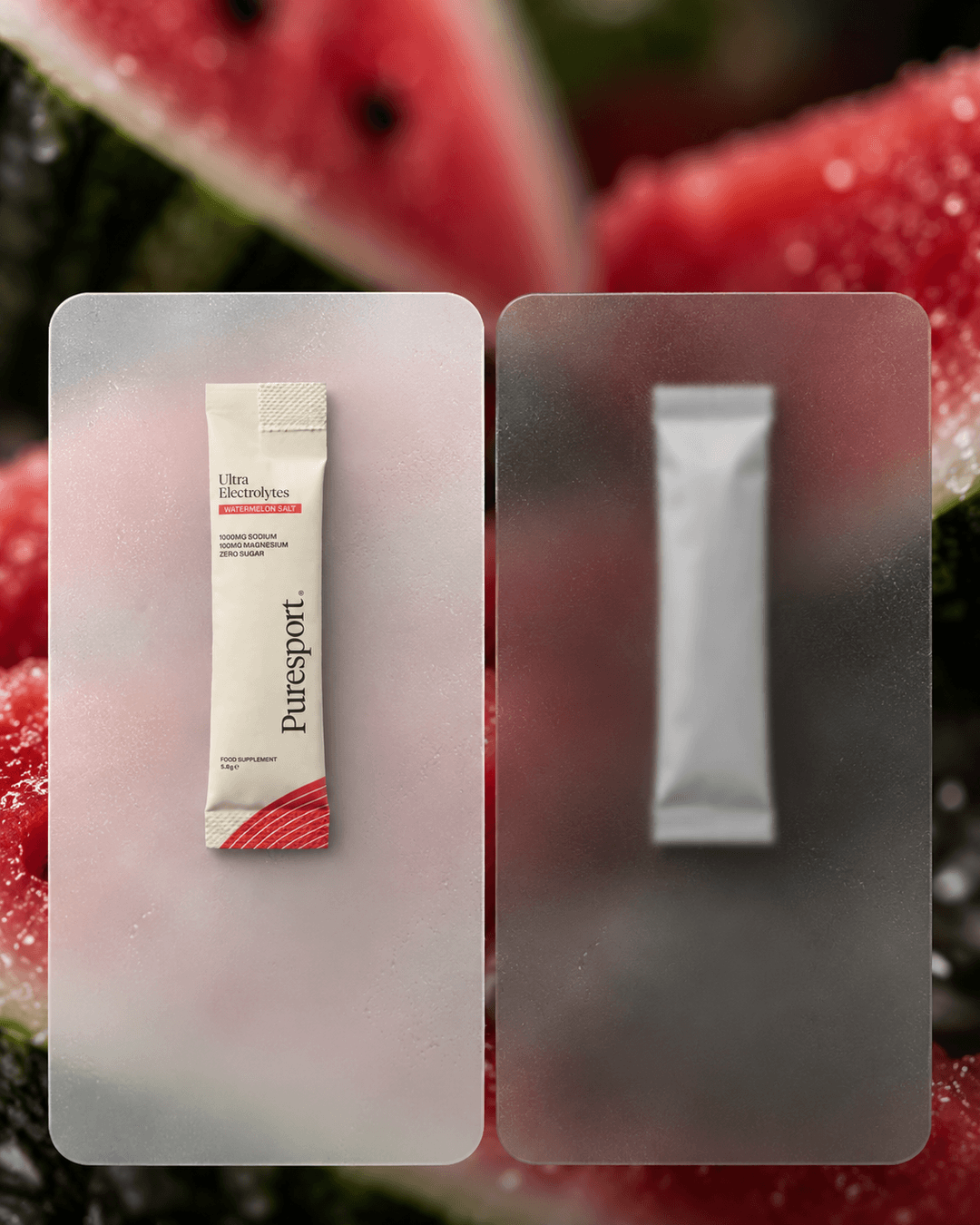 Two frosted glass panels over a blurred watermelon background, the left holding a Puresport Ultra Electrolytes sachet and the right a plain white sachet, with no text added.