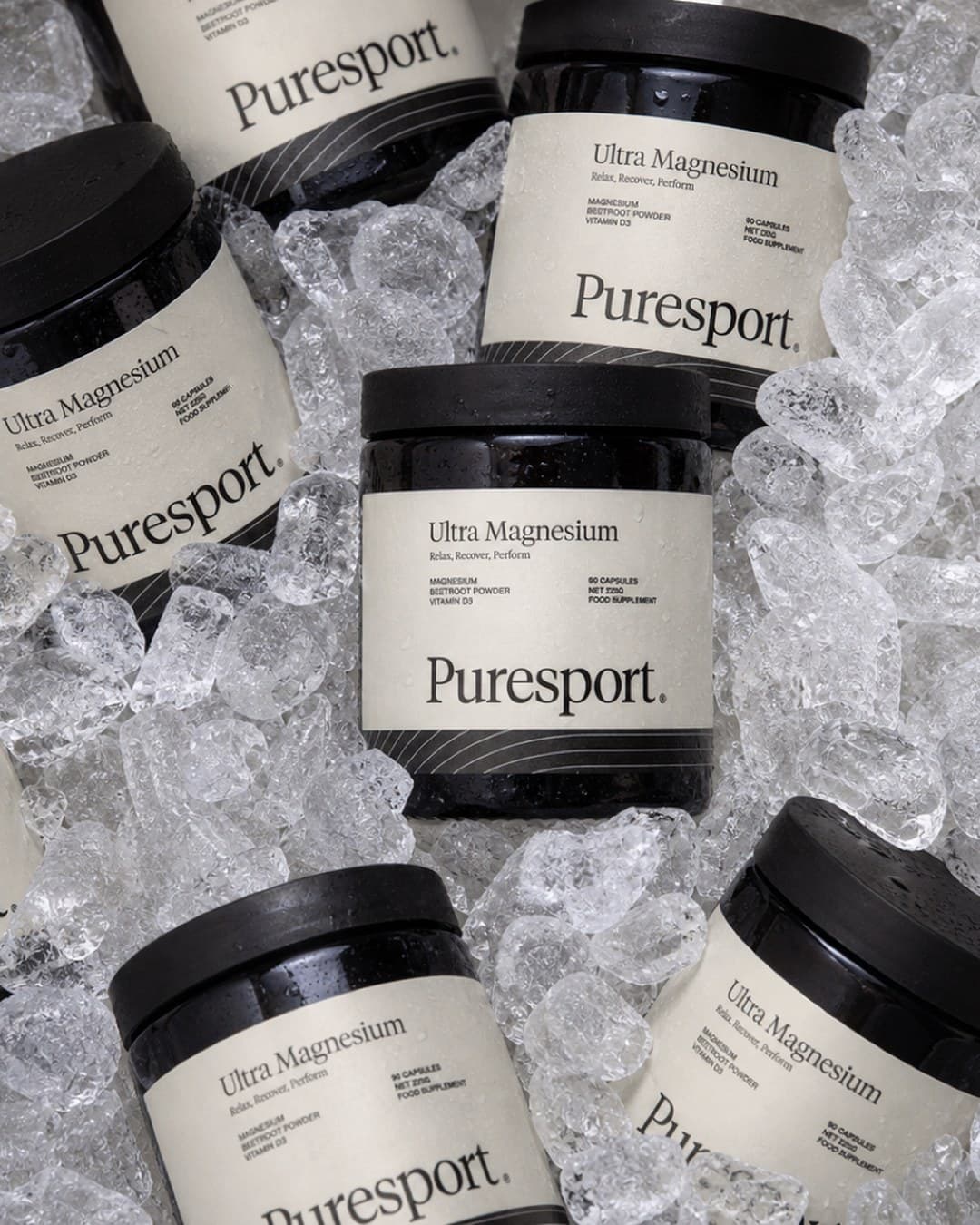 Puresport Ultra Magnesium jars scattered across crushed ice