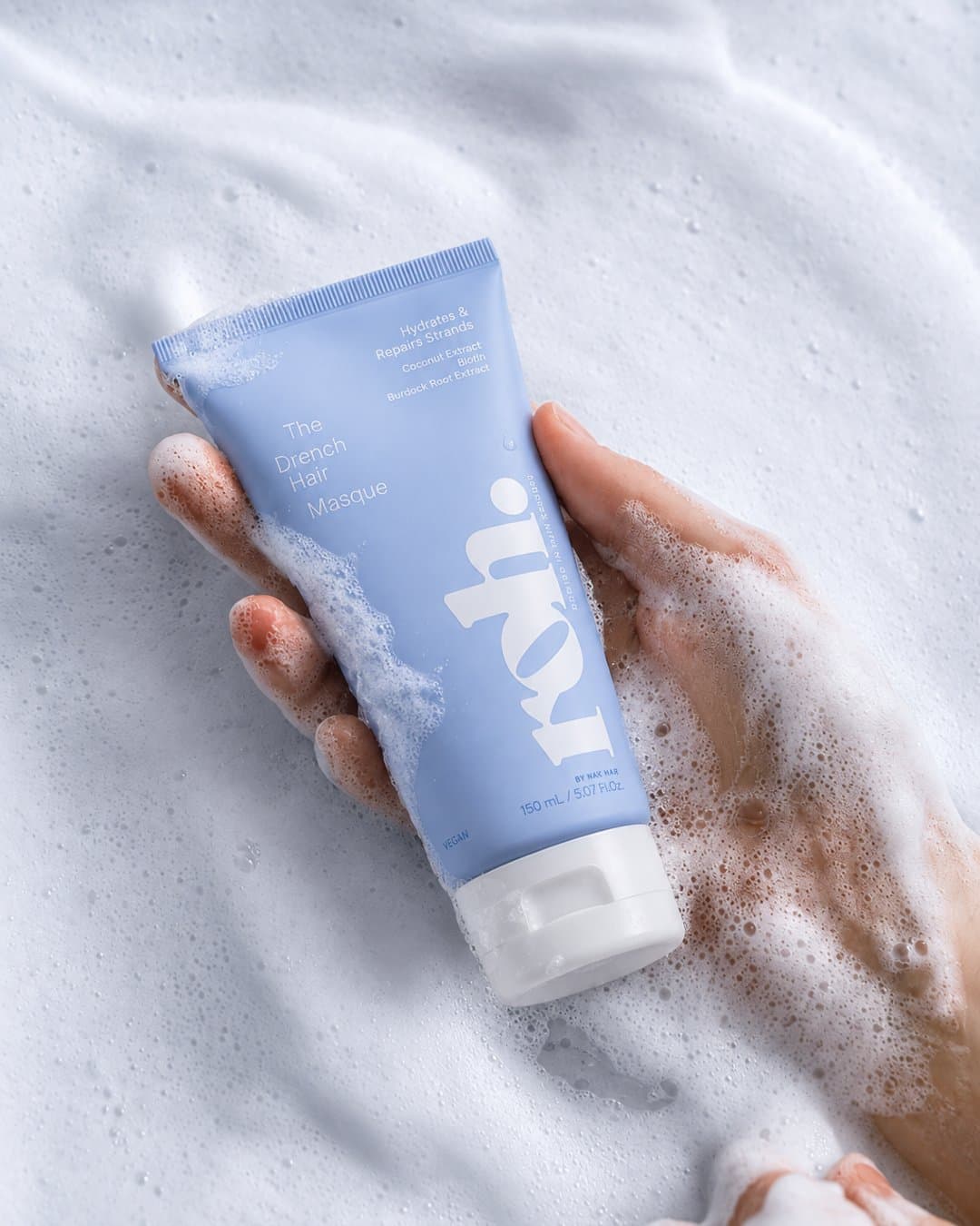 Hand holding a ROH masque tube in white foam