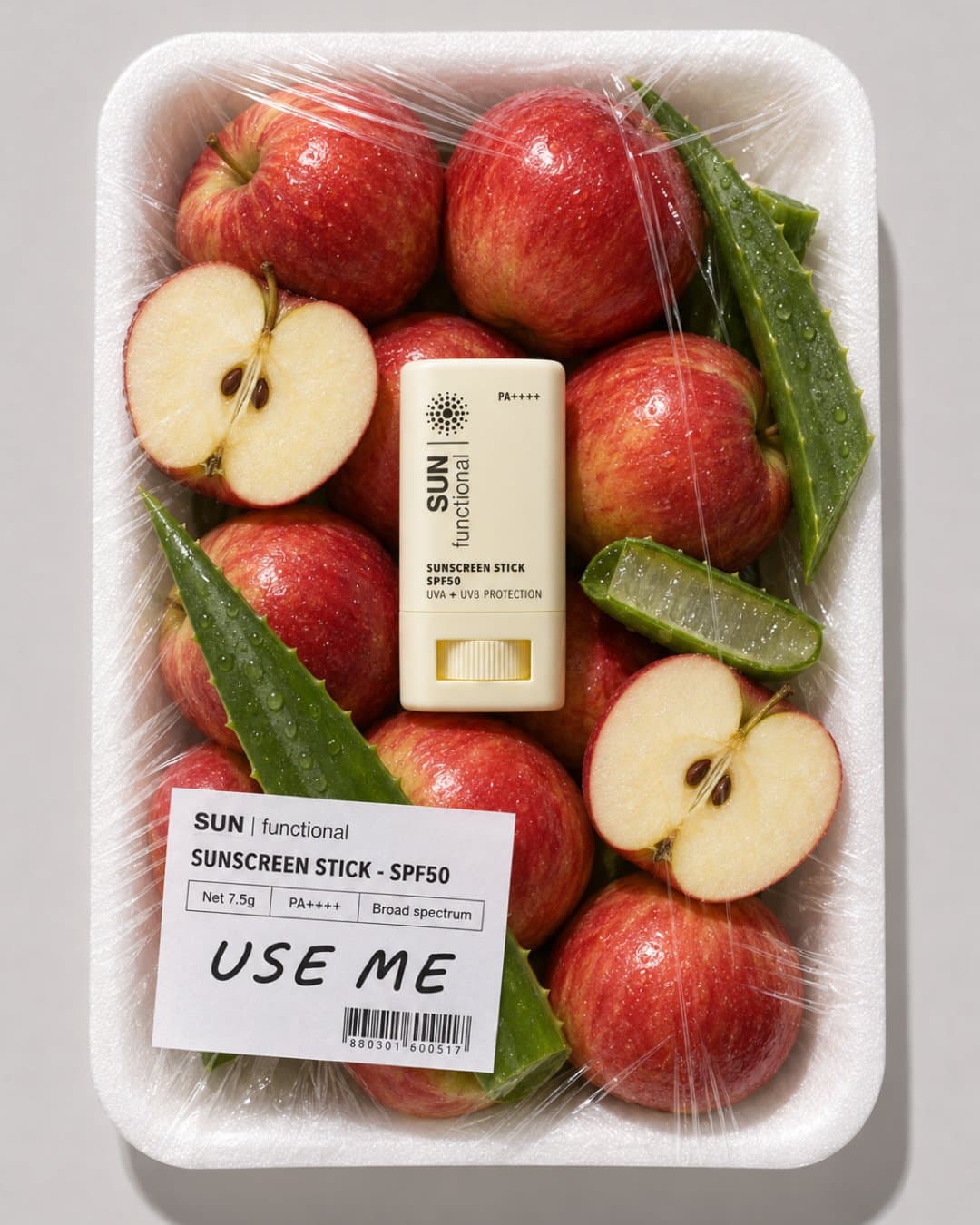 Sunscreen stick in a foam tray of apples and aloe with a Use Me label