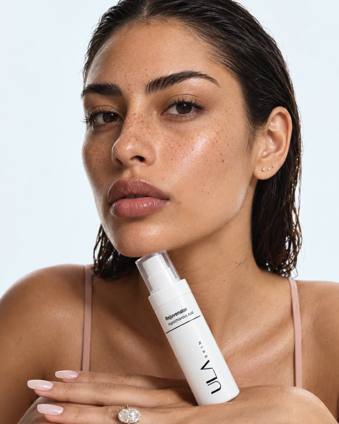 Model with a ULA spray bottle held under her jaw