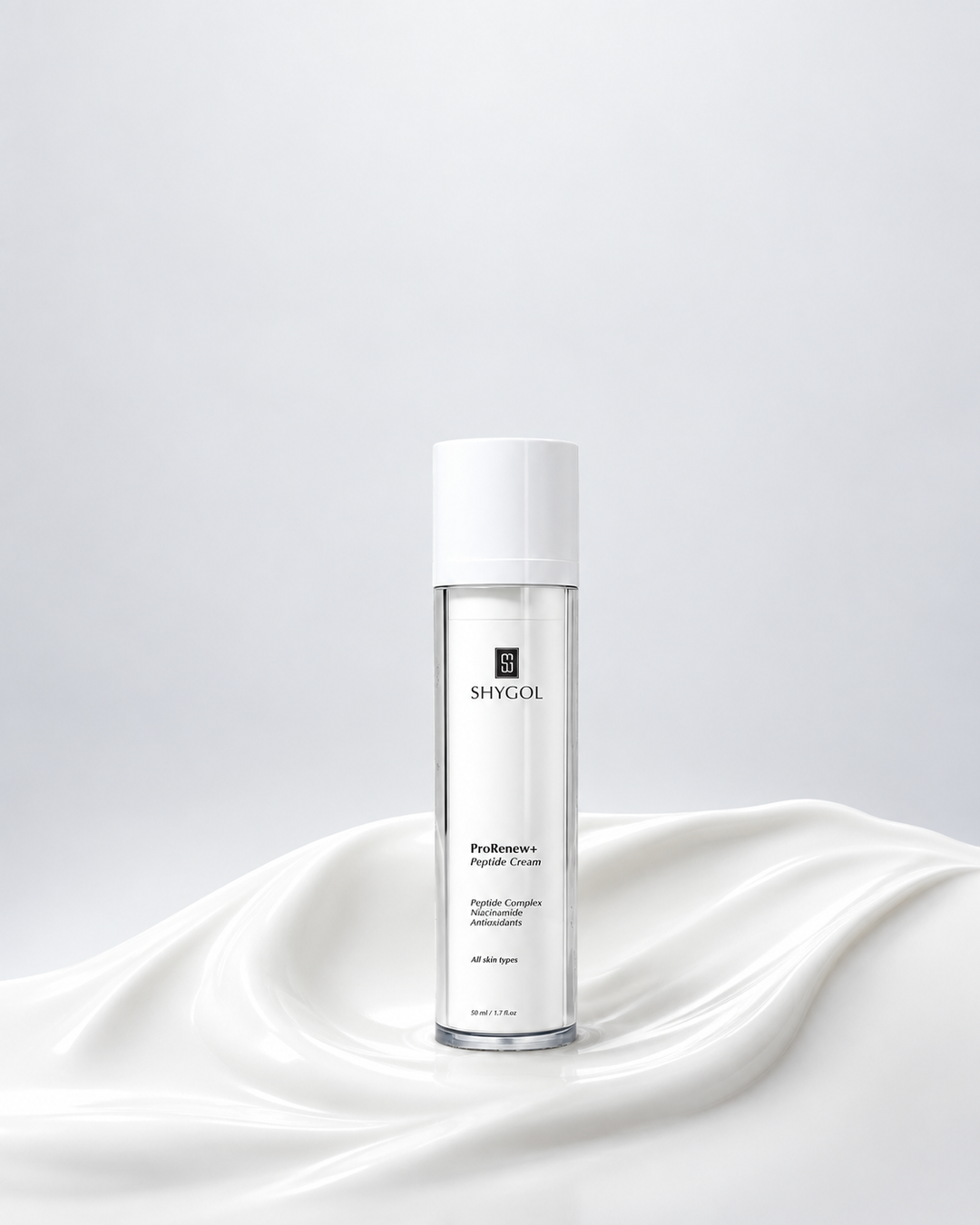 A Shygol ProRenew+ Peptide Cream bottle standing in a swirl of white cream against a soft grey backdrop, with no text or graphics added.